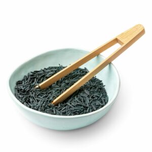 Whole spirulina crunchies in a bowl with tongs